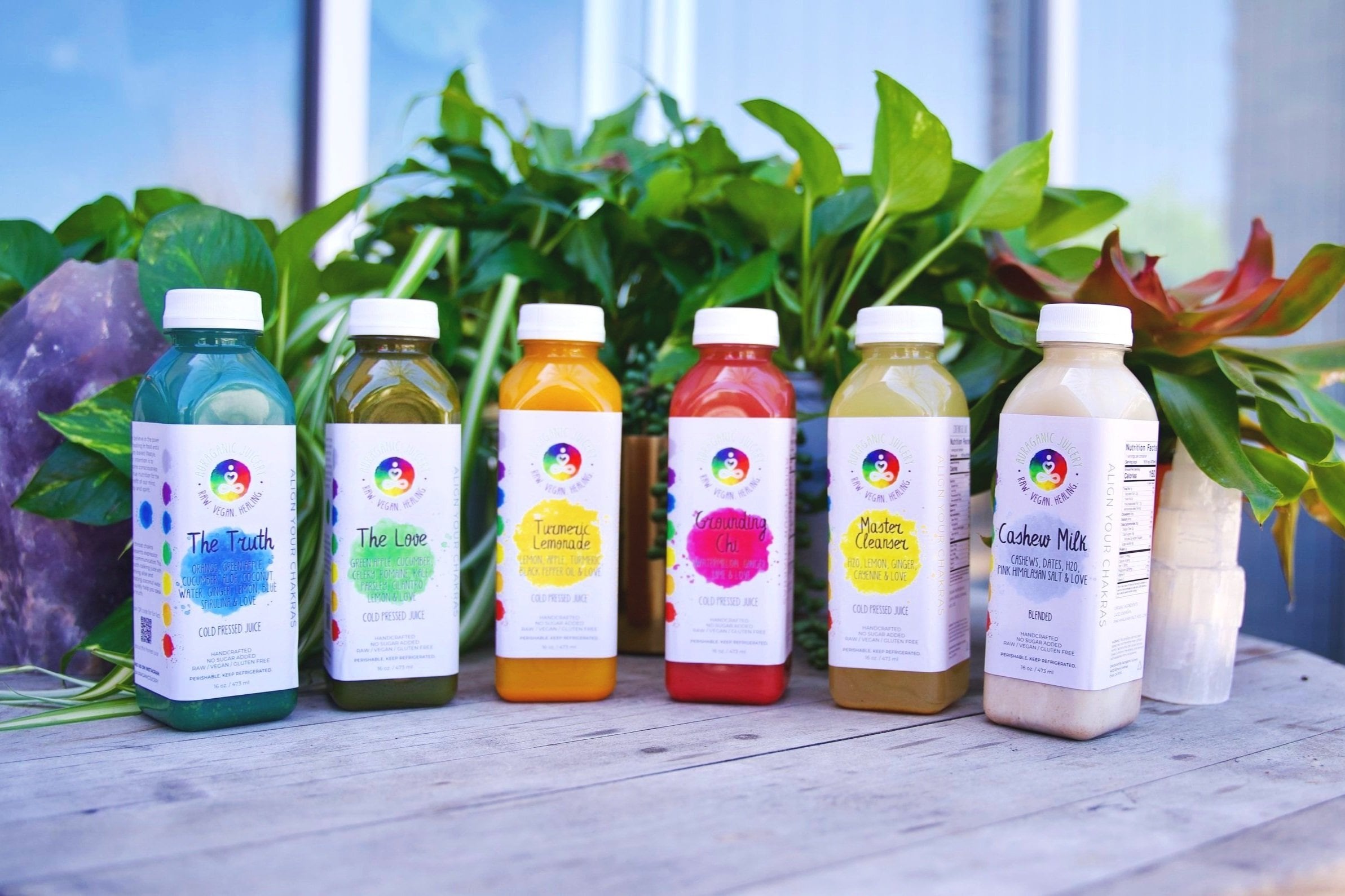 Auraganic juice bottles on a wooden table